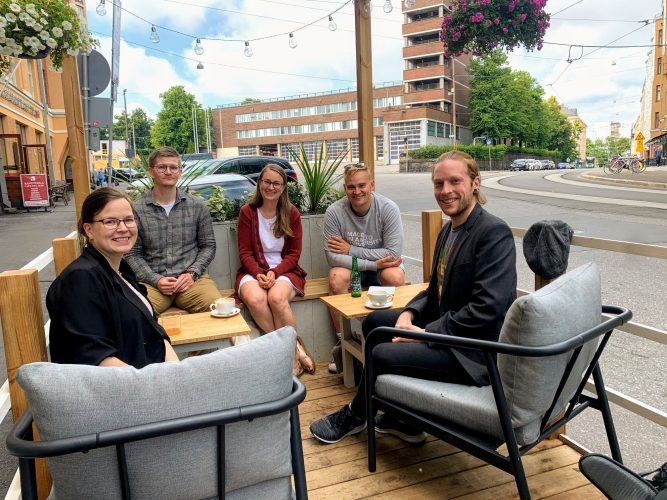 Changemakerin puheenjohtaja Petteri Näreikkö sekä koordinaattori Matias istuvat kansanedustajien Inka Nokson ja Atte Harjanteen kanssa kahvilan terassilla.